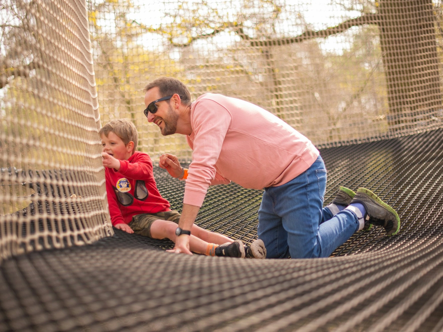 A boy and his dad take int he view from a Go Ape Nets Adventure course