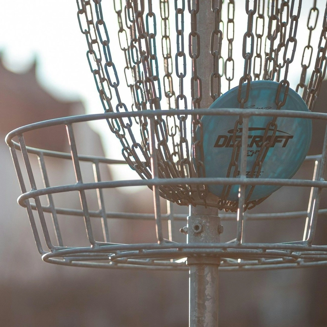 A disc golf frisbee in a chain target